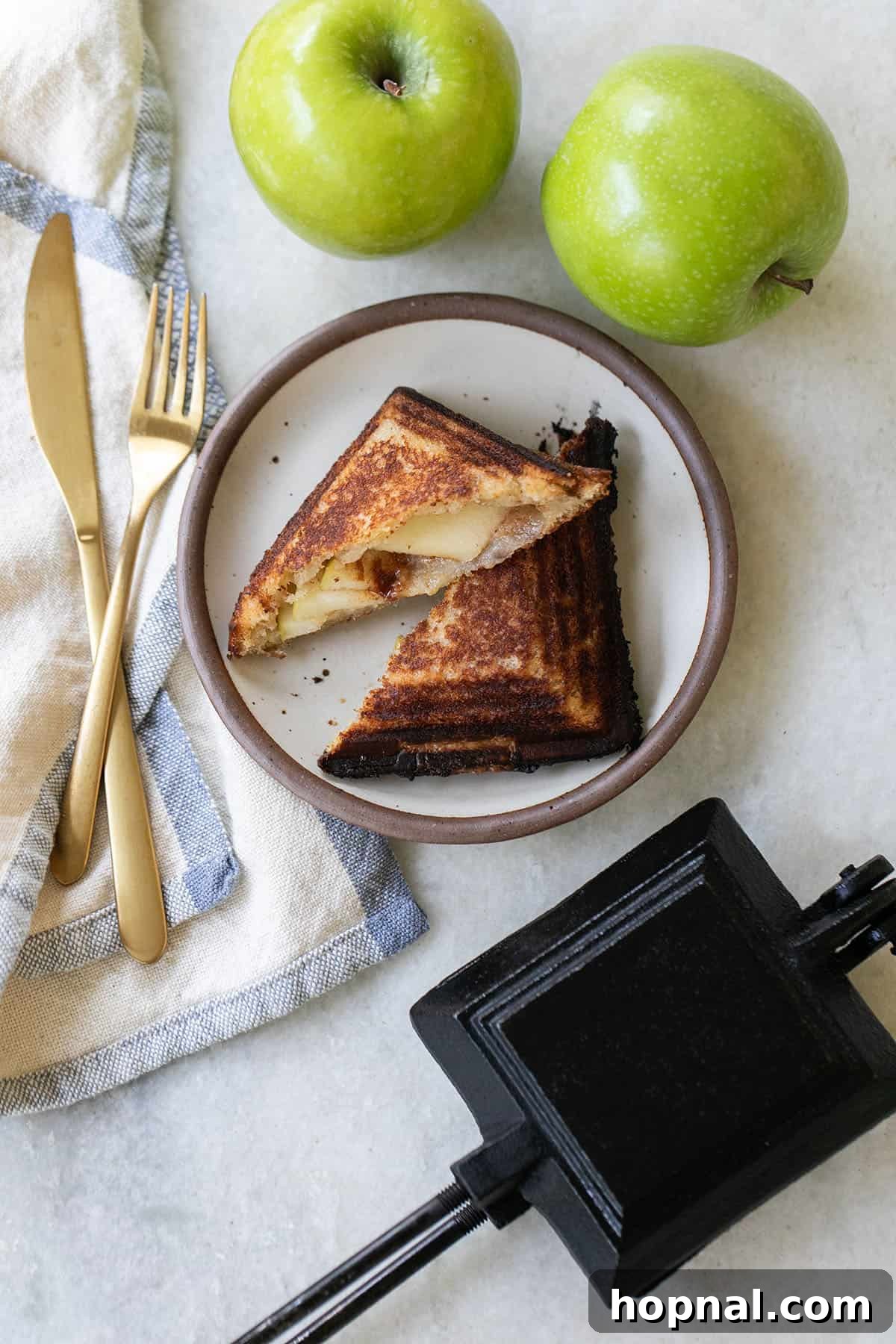 Delicious campfire apple pies and a cast iron pie maker ready for cooking over fire