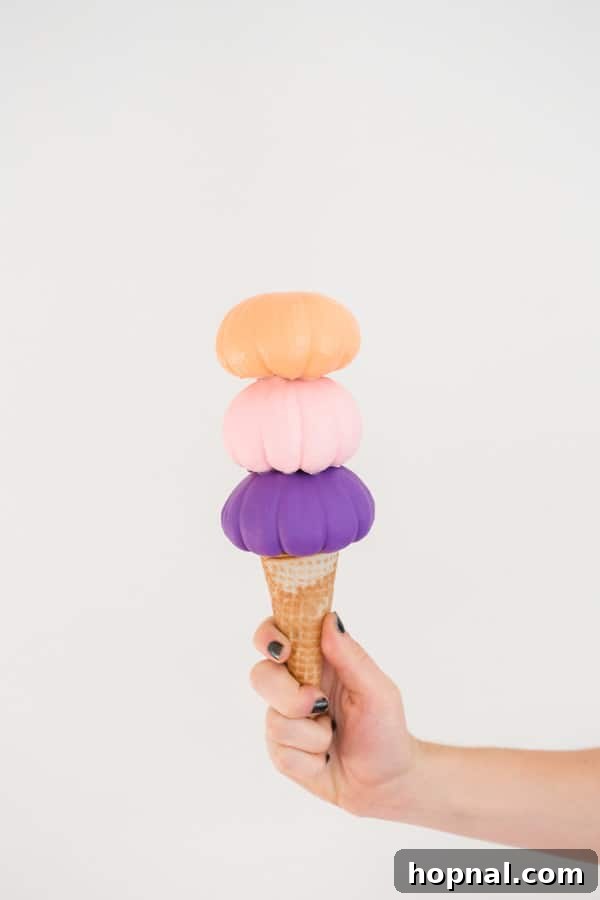 Sweet Autumn: Homemade Pumpkin Ice Cream Cones 9 Three finished mini pumpkin ice cream cones displayed together, showcasing variety and charm