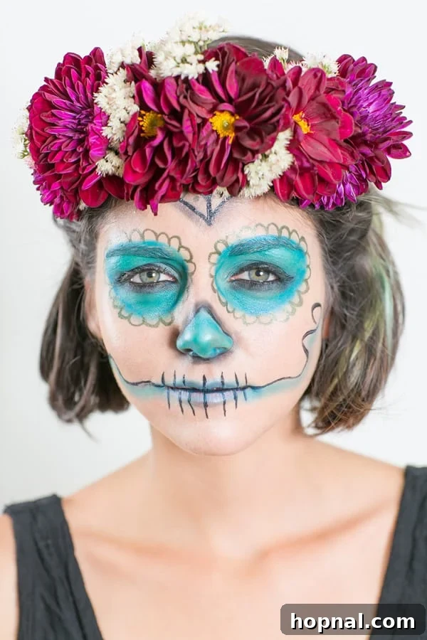 Effortless Día de los Muertos Makeup & DIY Flower Crown Guide 2 Model showcasing easy Day of the Dead makeup with vibrant turquoise and intricate designs