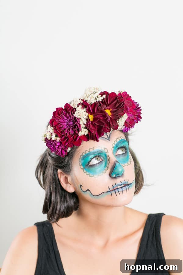 Effortless Día de los Muertos Makeup & DIY Flower Crown Guide 7 Model with a festive floral crown and intricate Day of the Dead makeup looking directly at the camera