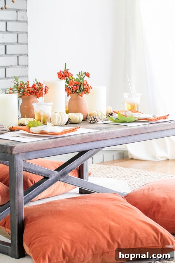 Little Gobblers' Thanksgiving Table 2 A beautifully set wooden coffee table for kids' Thanksgiving dinner, adorned with orange throw pillows, pumpkins, and easy Thanksgiving craft ideas.