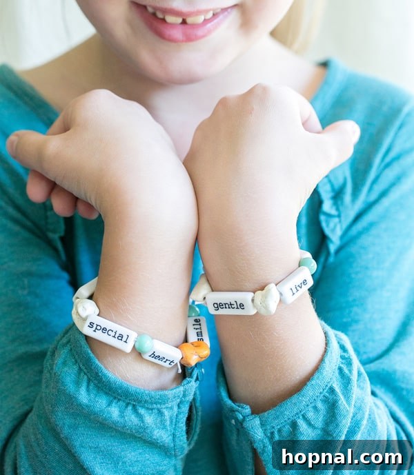 Little Gobblers' Thanksgiving Table 12 A little girl proudly displaying her DIY Thanksgiving bracelets, a fun and creative craft for kids.