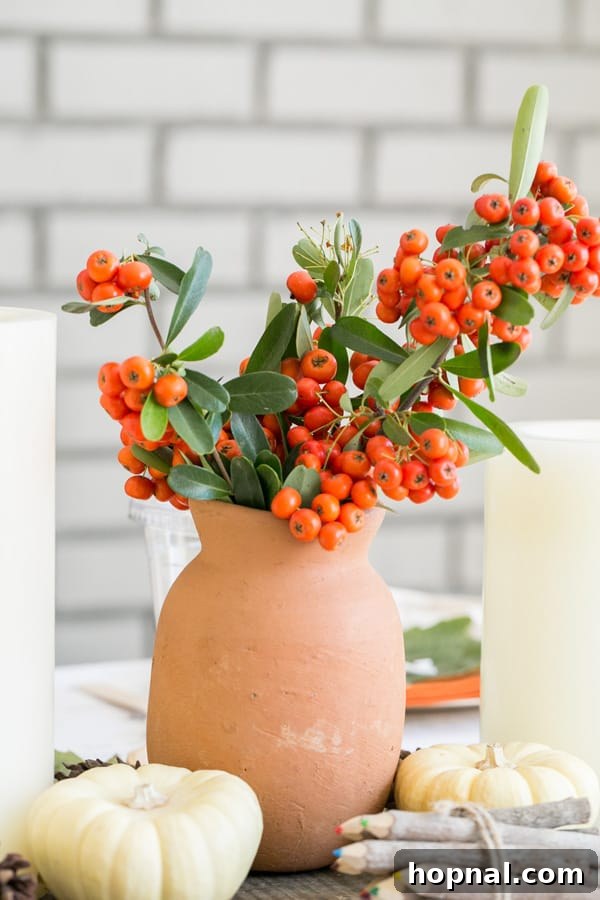 Little Gobblers' Thanksgiving Table 7 A clay vase holding vibrant red berries, a simple yet elegant natural decoration for the Thanksgiving table.