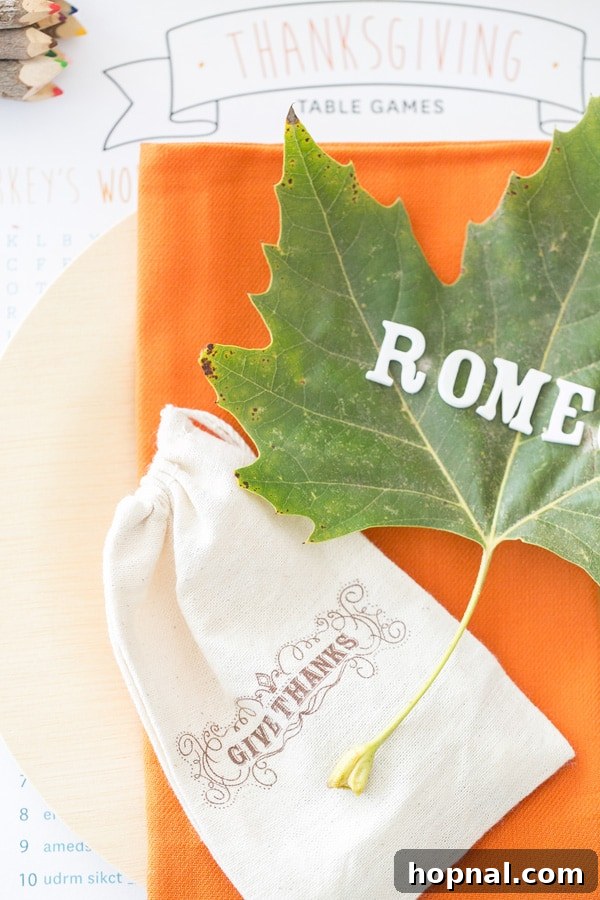 Little Gobblers' Thanksgiving Table 8 A beautifully set kids' Thanksgiving table featuring orange napkins, bamboo plates, personalized leaf name cards, and a 'give thanks' drawstring bag.