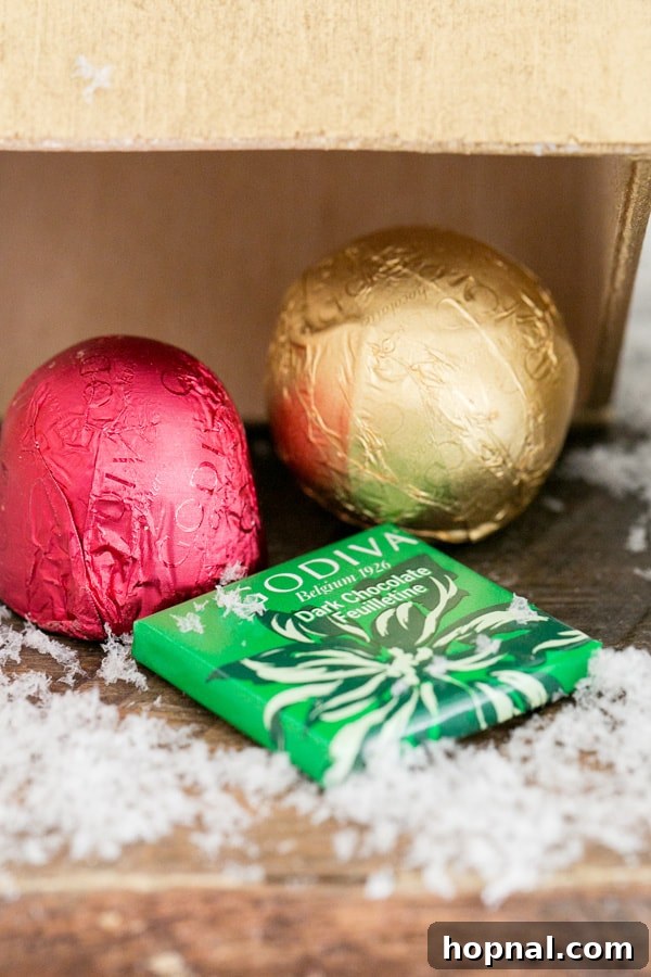 Close-up detail of a rich chocolate treat nestled underneath a wooden advent house, ready for discovery.