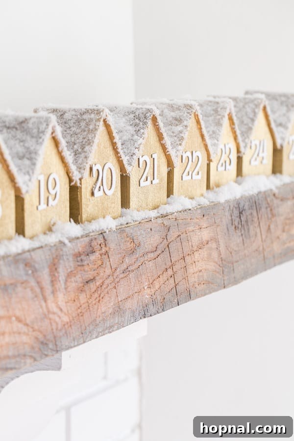 The full array of wooden advent houses charmingly lined up on a mantlepiece, creating a picturesque holiday display.