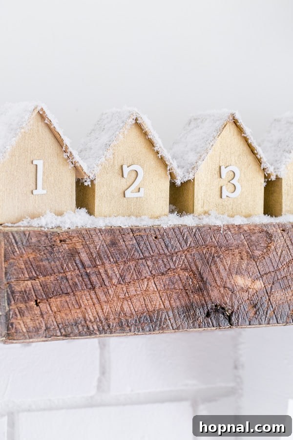 Close-up view of the handcrafted wooden houses of the DIY Advent Calendar, showcasing intricate details and festive adornments.