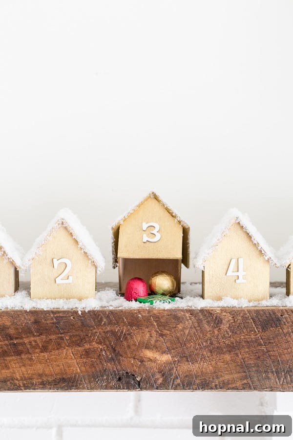 A wooden advent house lifted to reveal a delicious chocolate treat hidden underneath, ready for a daily surprise.