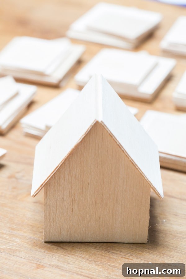 An unpainted wooden house for the DIY Advent Calendar, showing its raw, natural Balsa wood finish before decoration.
