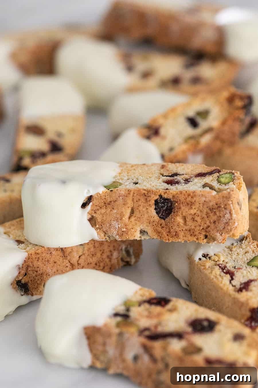 Jeweled Cranberry Pistachio Biscotti 3 Close-up of cranberry pistachio biscotti dipped in white chocolate, ready for serving.
