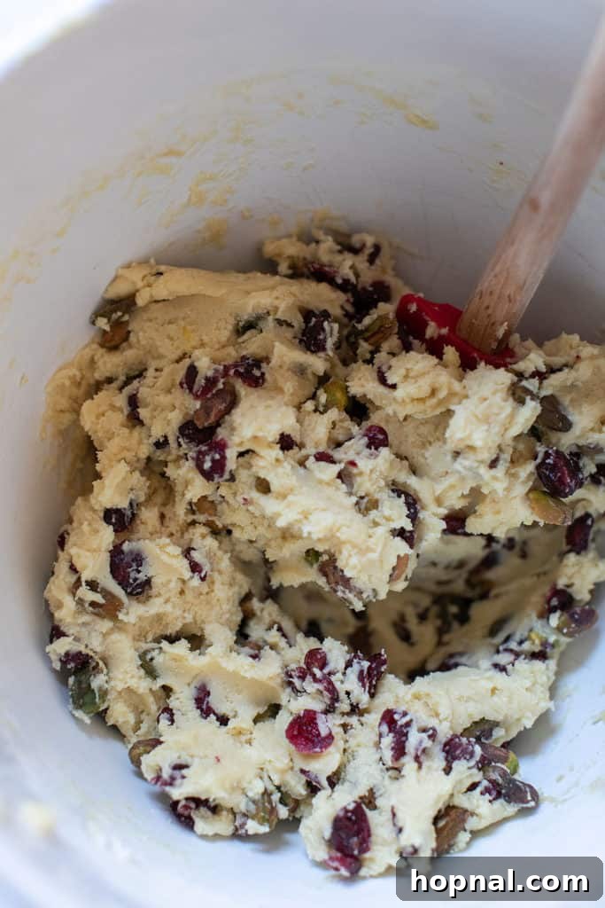 Jeweled Cranberry Pistachio Biscotti 8 The biscotti dough being mixed with cranberries and pistachios, highlighting the colorful additions.
