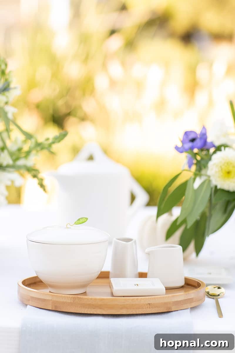 An elegant tea set arranged beautifully at a tea party, with a focus on brewing loose leaf tea for a refined experience.