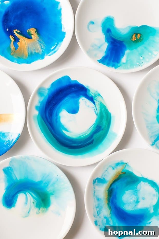 Overhead view of blue watercolor plates on a white surface