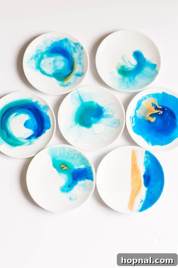 Seven blue and gold watercolor plates arranged on a white background