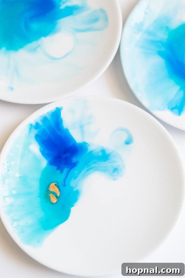 Close up picture of watercolor paint blending on a white plate