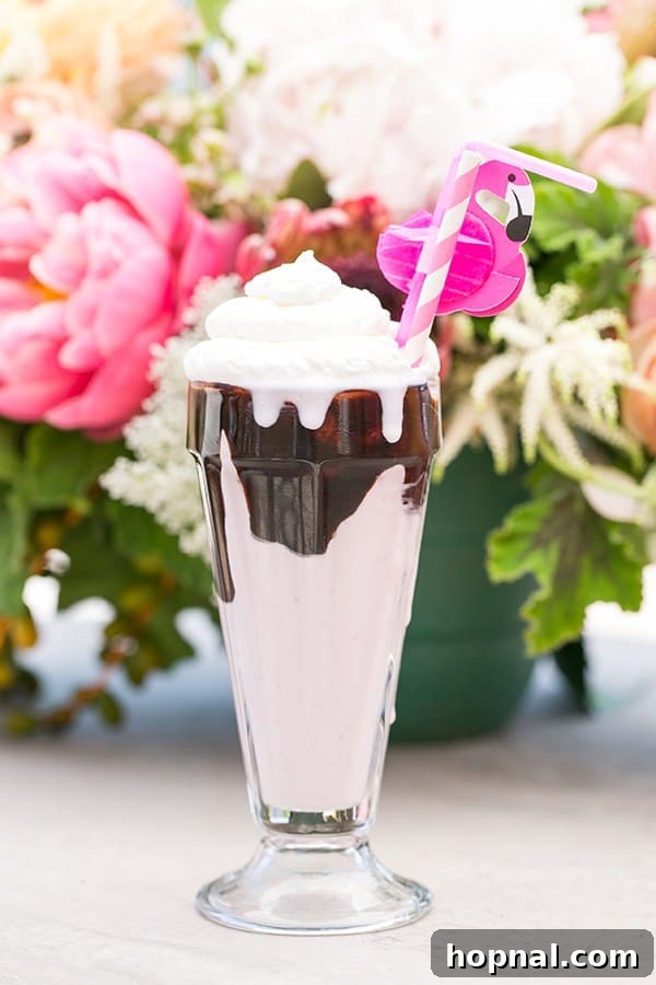 Strawberry milkshake with a flamingo straw, a delightful drink for a flamingo pool party