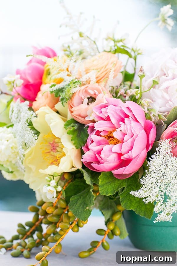 A vibrant arrangement of pink, yellow, and orange flowers, perfect for a summer party
