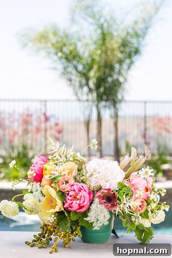 Pink, green, and yellow summer pool party flowers in a stylish arrangement