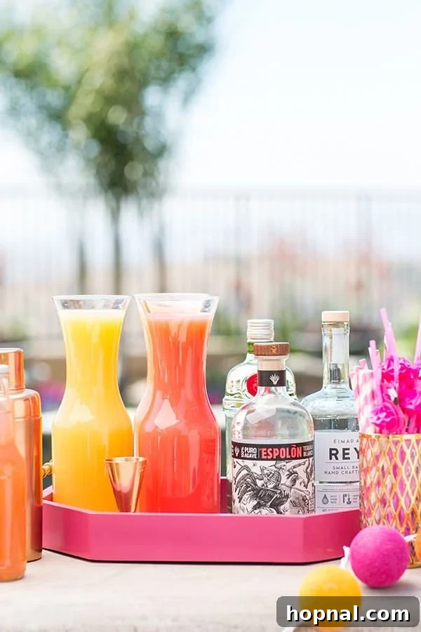 A well-stocked cocktail station featuring fresh juices and spirit bottles, ready for mixing