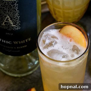 A close-up of the 'Totally Fuzzed' white wine cocktail, perfectly mixed and ready to enjoy, highlighting its inviting color and texture.