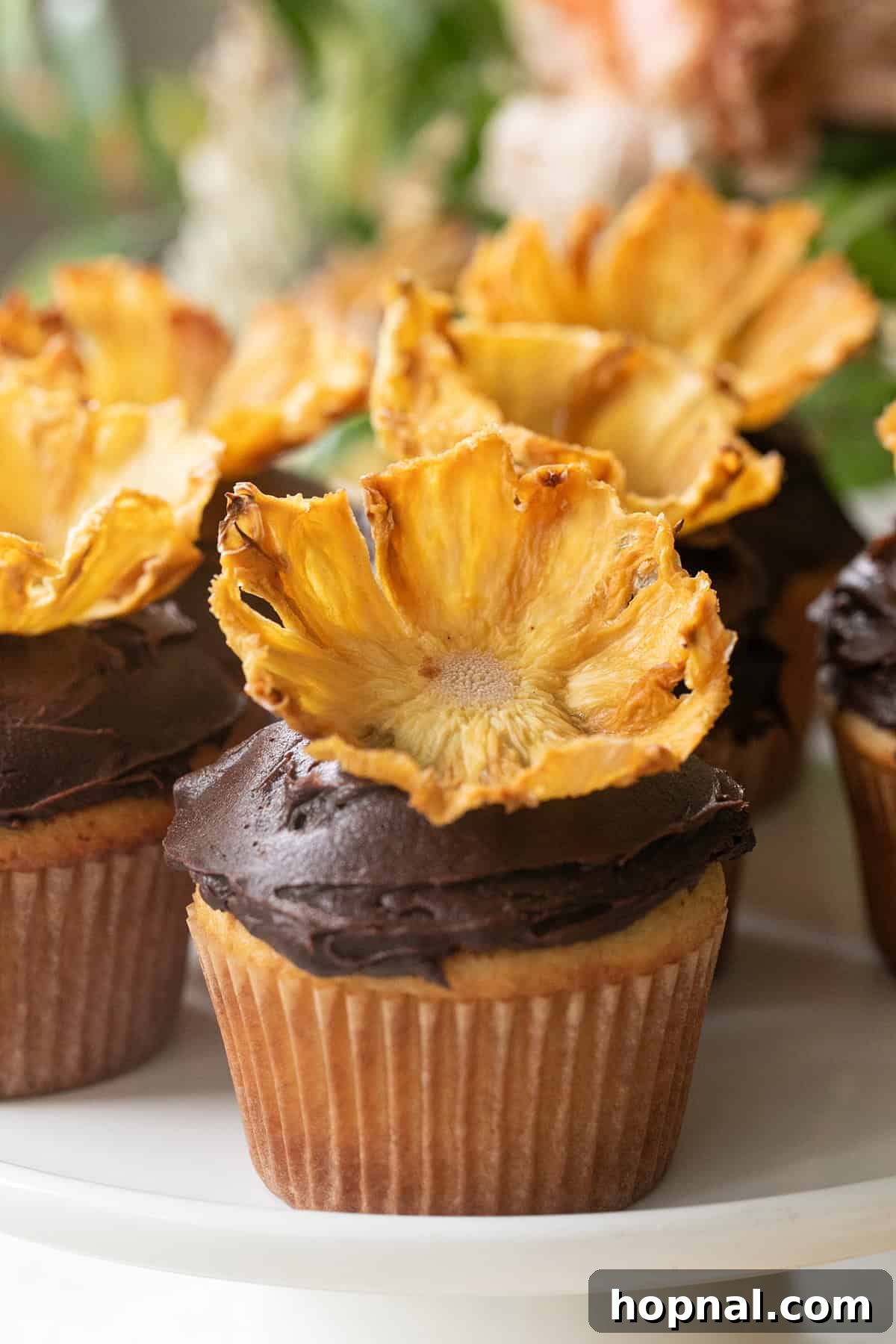 Pineapple flowers adorning a batch of freshly baked cupcakes, showcasing their delicate, edible beauty as a perfect dessert topping.