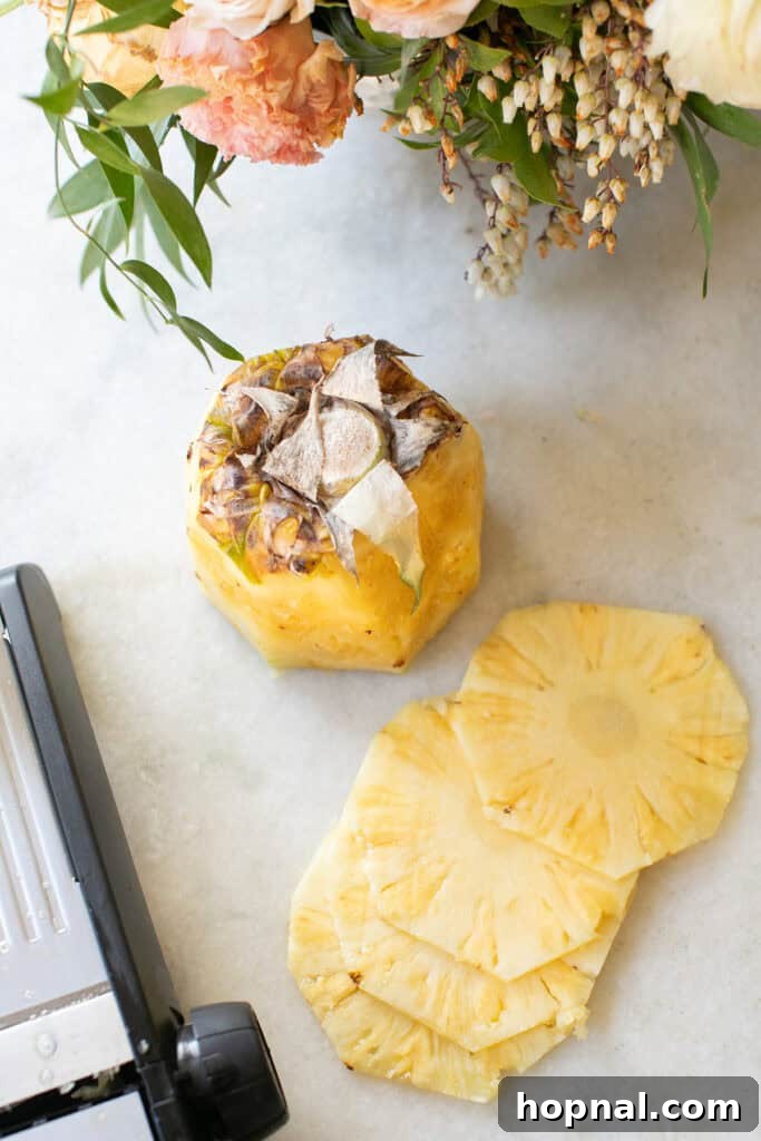 Uniformly sliced pineapple rounds arranged neatly on a surface, showcasing their consistency.