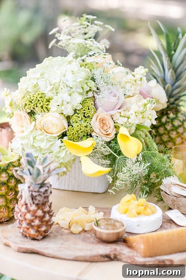 A vibrant tropical flower arrangement adorning a table, accompanied by a charming baby pineapple.