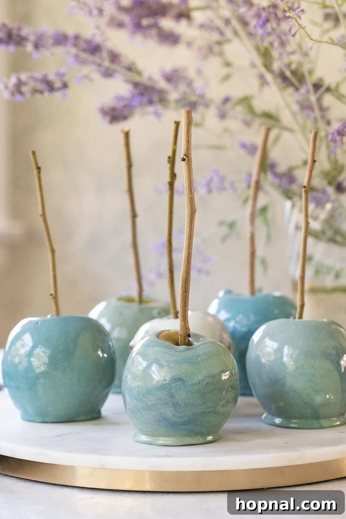 A festive array of colorful marbled candy apples thoughtfully arranged on a platter, creating a vibrant centerpiece for a fall gathering.