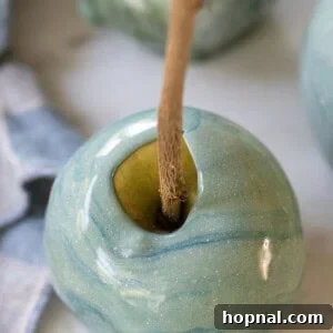 A vibrant blue candy apple, ready to be enjoyed as a sweet treat.