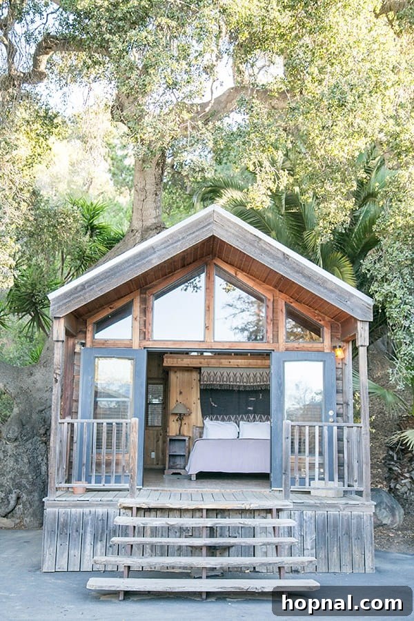 Cozy cabin in the woods, perfect for a Thanksgiving glamping experience, with hints of a warm Thanksgiving dinner setup.