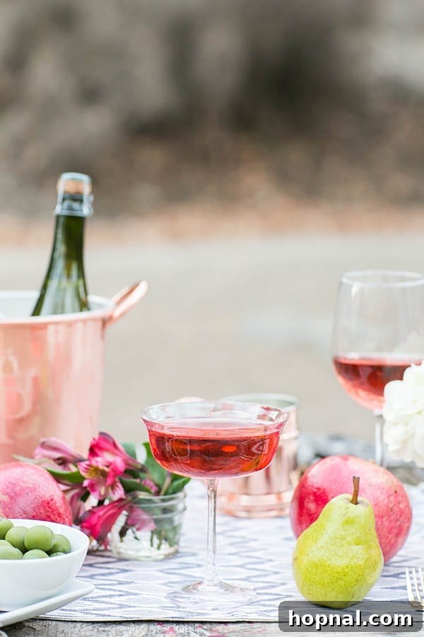 A close-up of a festive holiday cocktail, garnished beautifully, adding elegance to an outdoor Thanksgiving feast.
