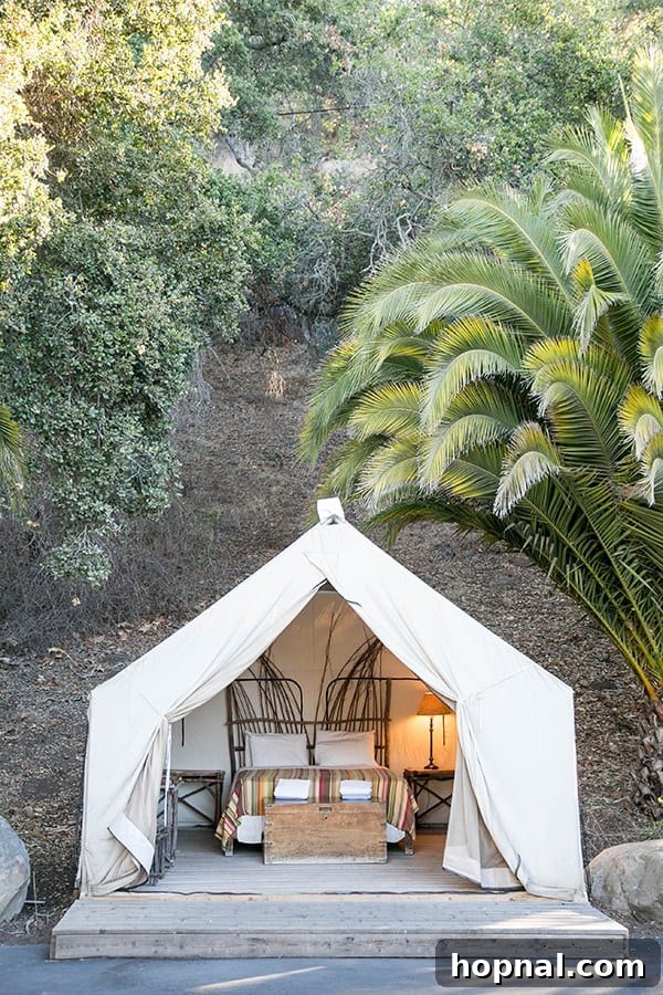 A luxurious glamping tent set up in a scenic outdoor location, showcasing a comfortable and stylish camping option.