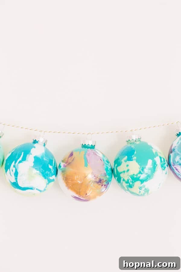 A string of colorful Homemade Marbled Christmas Ornaments