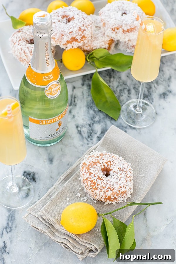 Side shot of a beautifully decorated table with sparkling wine bottles and glasses of peach punch