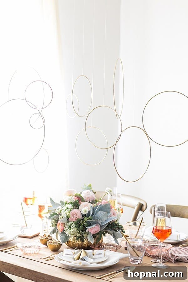 Decorative gold rings suspended from the ceiling, creating a festive New Year's Eve ambiance above a dining table.