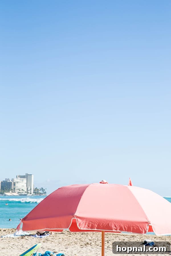 Pink umbrella on the beach.