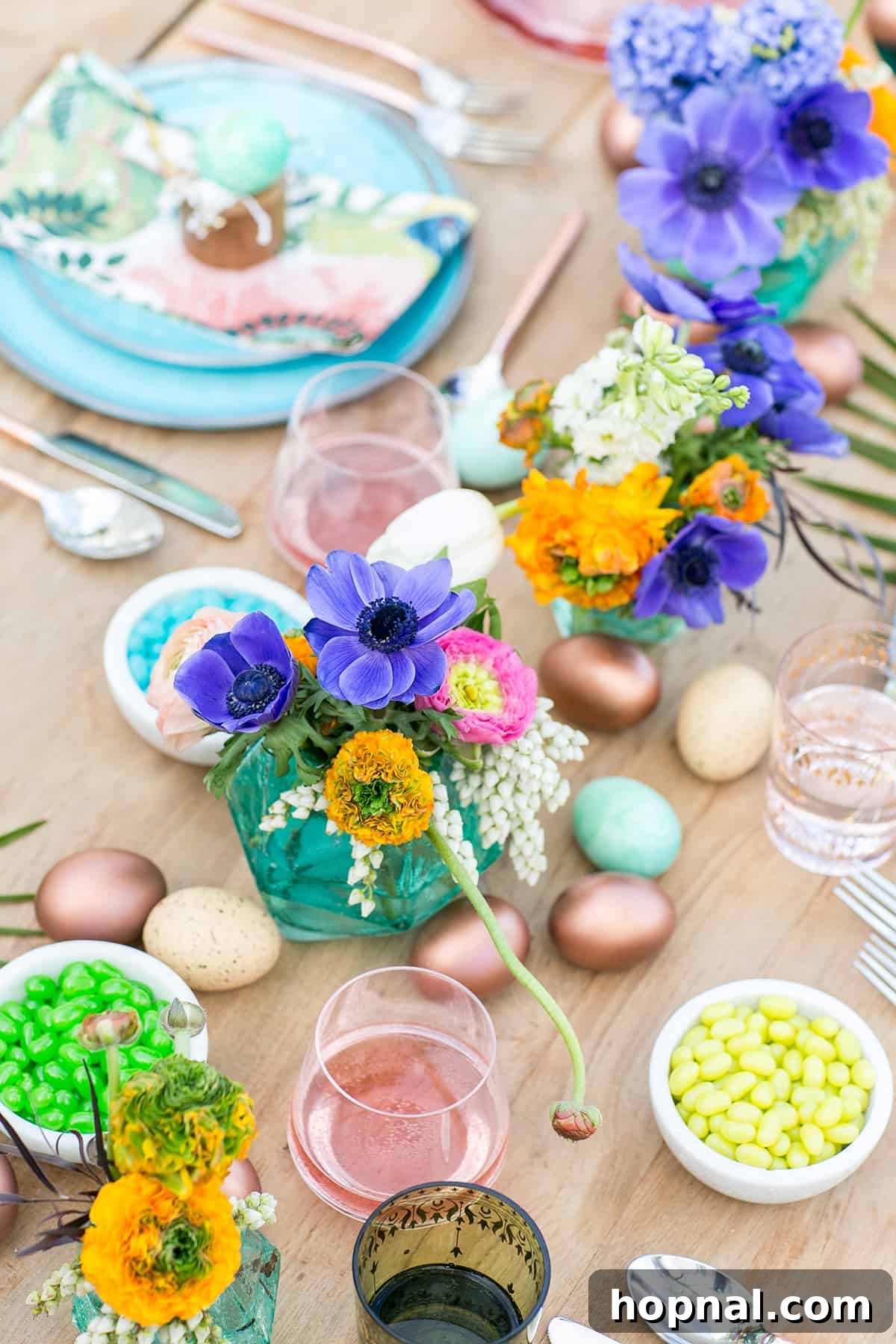 Colorful Easter party table setting with a Moroccan theme featuring bold colors and palm leaves for a unique spring celebration.