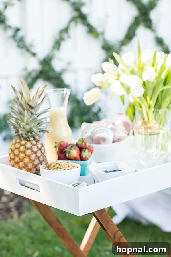 Dyeing for Easter Fun 13 An inviting outdoor setup featuring a healthy yogurt cup, a refreshing cocktail, fresh flowers, and a whole pineapple, symbolizing a perfect balance of fun and relaxation at a gathering.