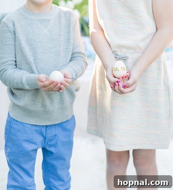 Dyeing for Easter Fun 14 Two joyful children holding their vibrantly decorated Easter eggs, proudly showcasing their artistic creations.