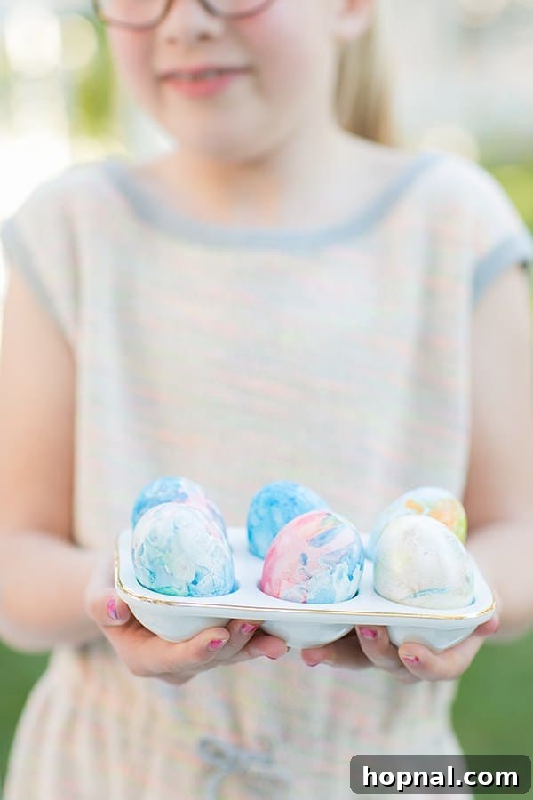 Dyeing for Easter Fun 16 A little girl proudly holding an egg crate filled with her beautifully dyed Easter eggs, showcasing her crafting efforts.
