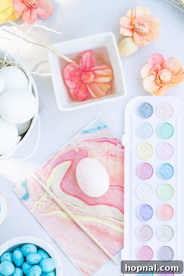 Dyeing for Easter Fun 17 A vibrant setup of watercolor Easter eggs, alongside paint palettes and brushes, inviting an artistic decorating session.