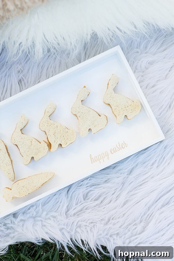Dyeing for Easter Fun 4 Adorable bunny-shaped sandwiches arranged on a festive serving tray that reads 'Happy Easter', ideal for a child-friendly party spread.
