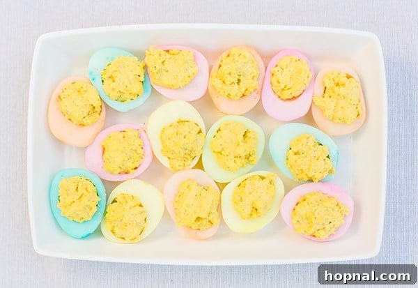 Dyeing for Easter Fun 5 A tray filled with colorful hard-boiled deviled eggs, showcasing various pastel hues, perfect for an Easter celebration.