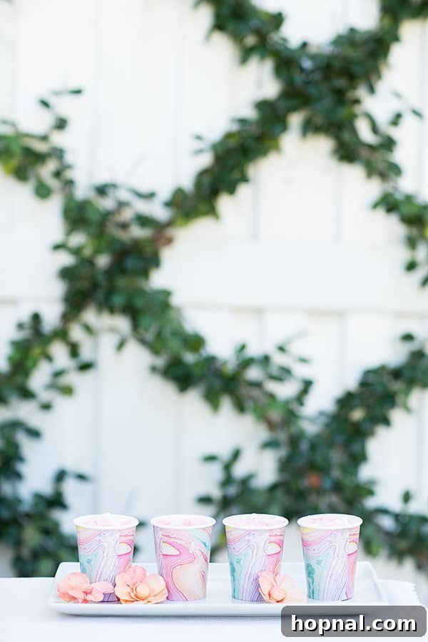 Dyeing for Easter Fun 6 Cozy white hot chocolate served in charming watercolor paper cups, perfect for an Easter gathering.