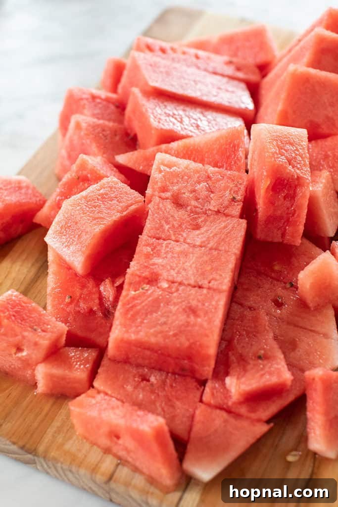 Cool Watermelon Quencher 3 Large chunks of vibrant red watermelon cut up and ready for blending.