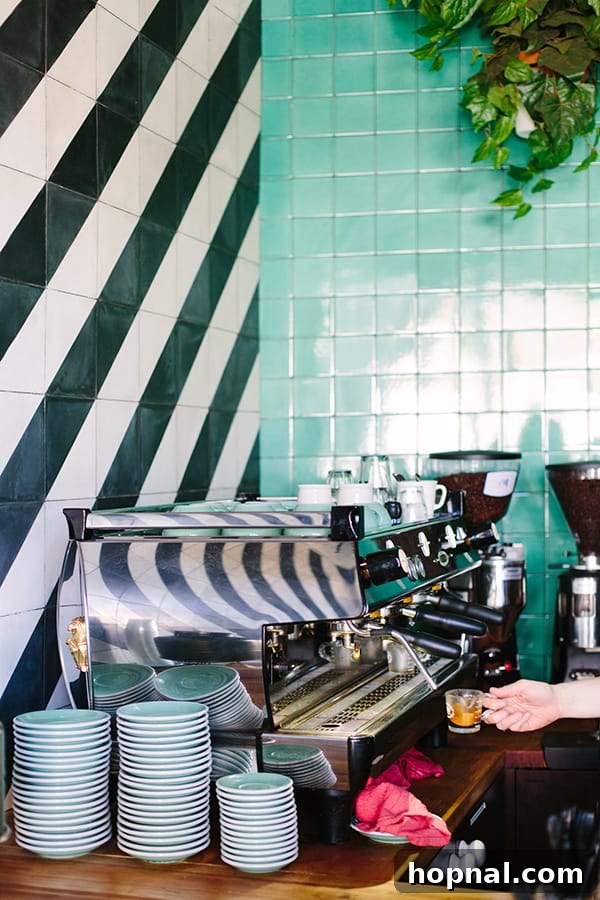 Espresso machine with coffee and green and black and white tile.