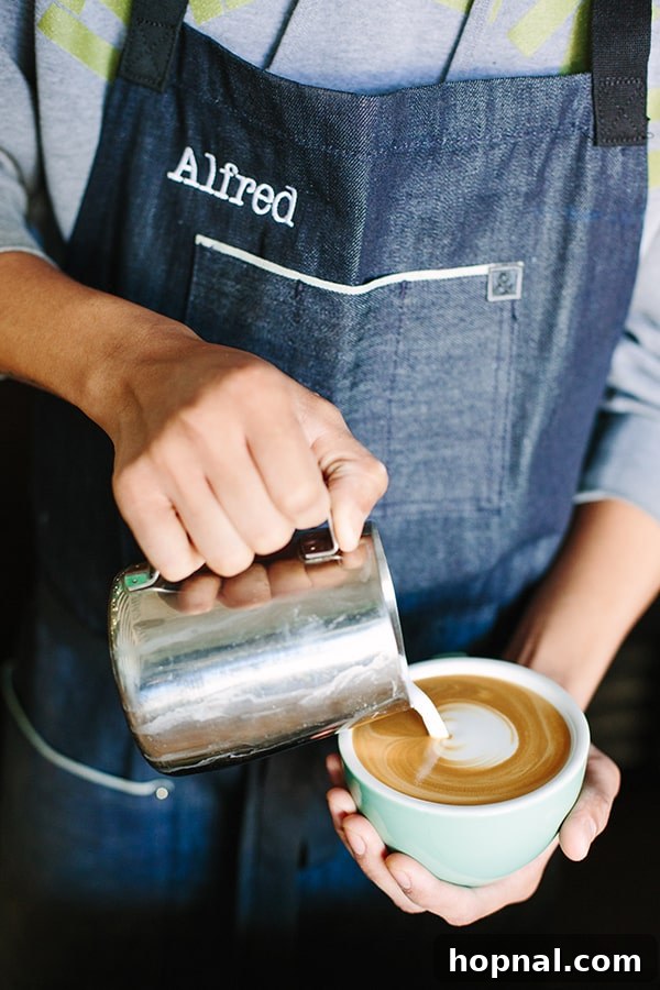Pouring a latte into a green cup