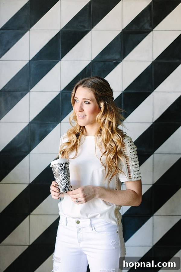 Eden Passante standing next to black and white tile at Alfred Coffee 