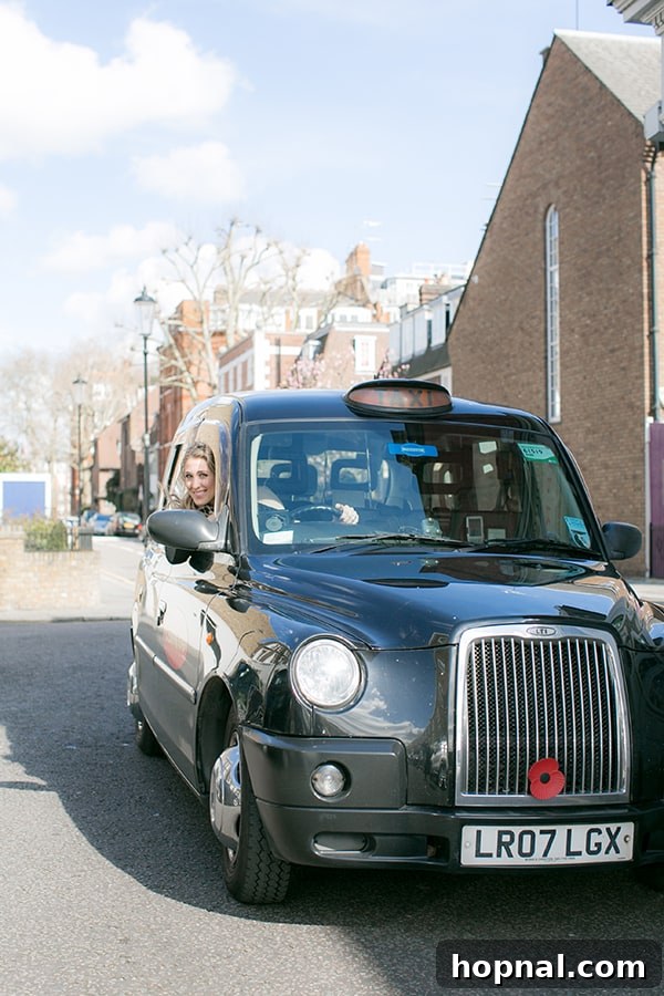 A person playfully driving a classic British taxi