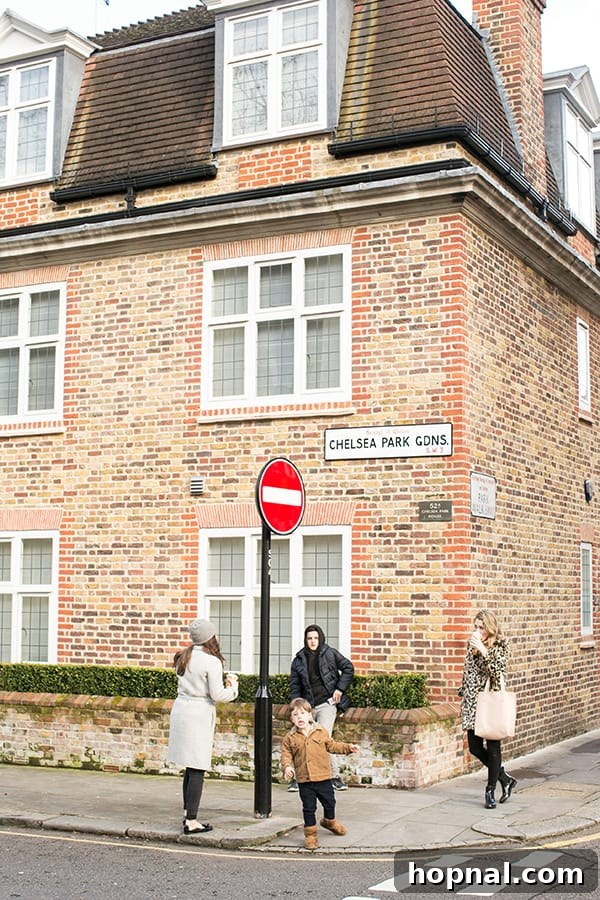 A woman standing elegantly at a London street corner